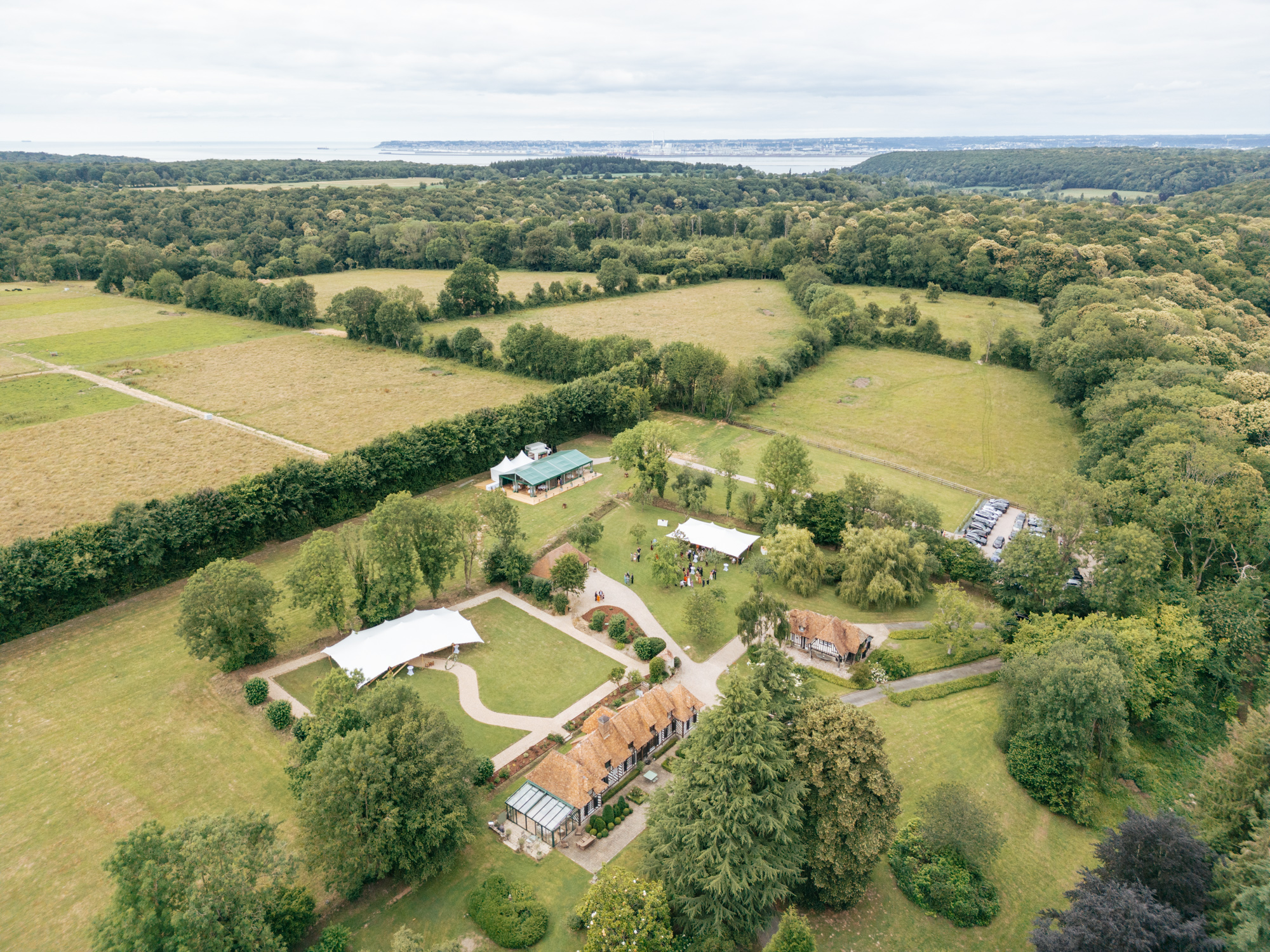 Outdoor wedding ceremony setup under a tent at Domaine de Barneville, with chairs arranged for guests.