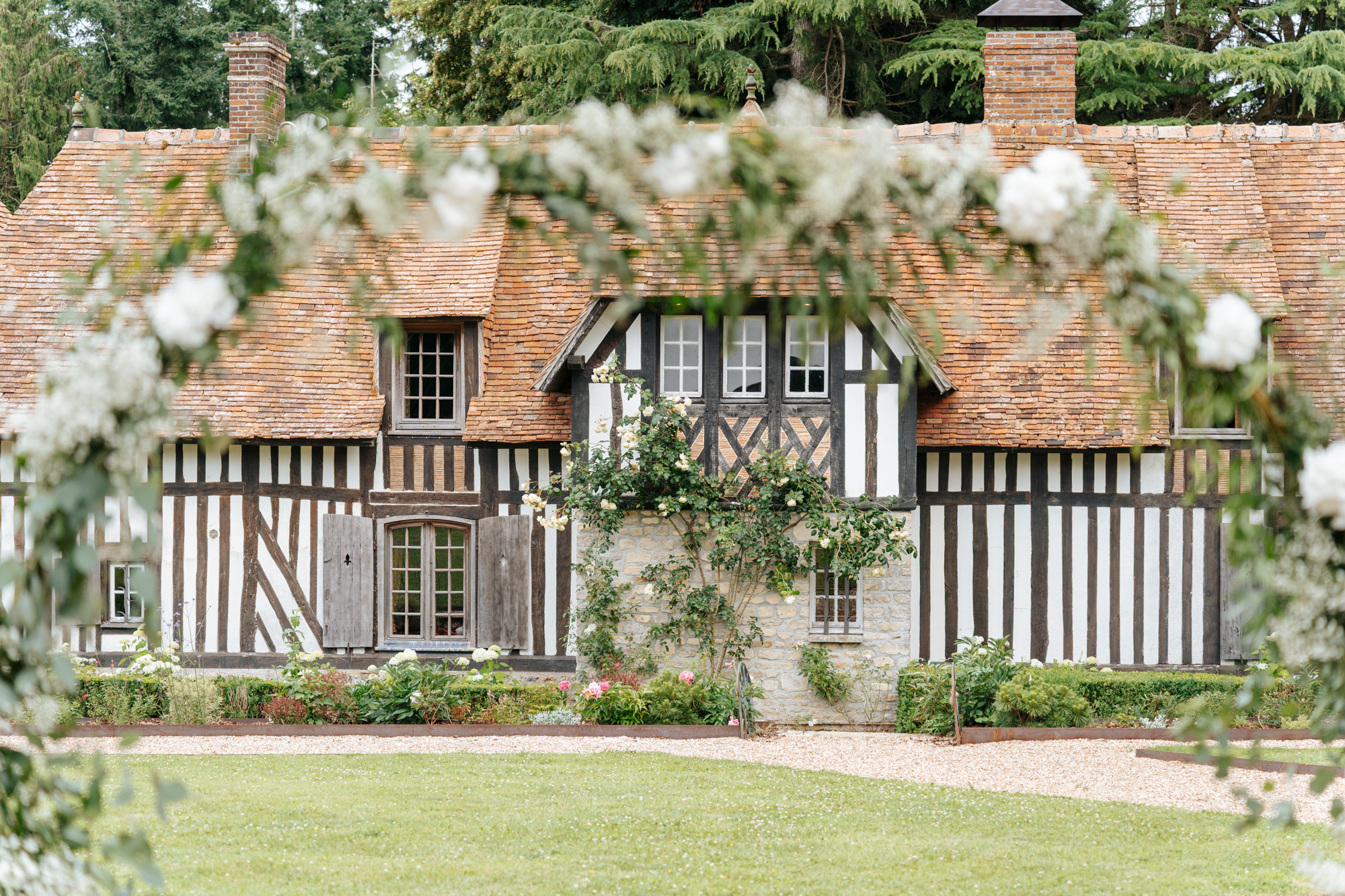 Large green marquee with wedding banquet tables inside at Domaine de Barneville.